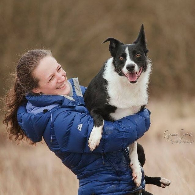 Zoe Lady in a blue puffer coat with a Border Collie